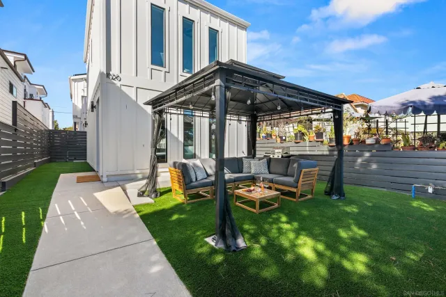 a view of a house with backyard and porch