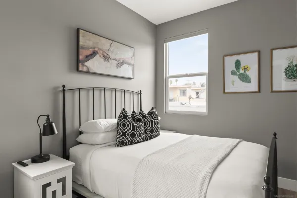 a bedroom with bed and a window