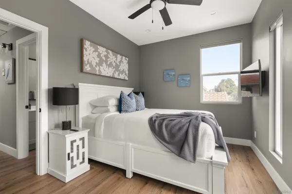 a bedroom with a bed and a flat screen tv