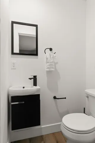 a bathroom with a toilet sink and mirror