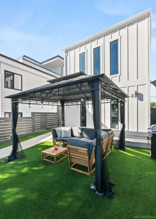 a backyard of a house with table and chairs
