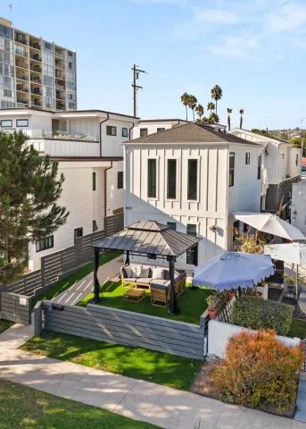 a front view of a house with swimming pool and porch