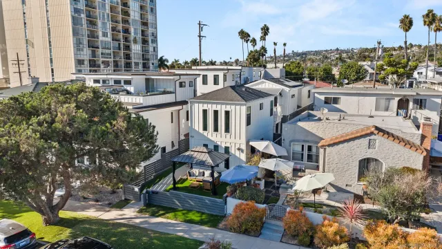 a front view of multiple houses with yard