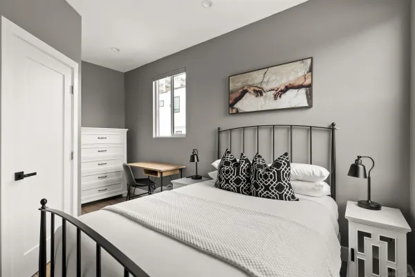 a bedroom with a bed and a dresser