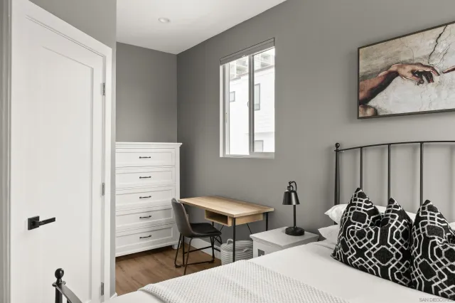 a bedroom with a bed and a dresser