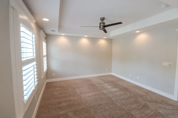 a view of a livingroom with a ceiling fan and window