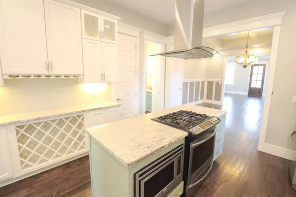 a kitchen with granite countertop a sink and a stove top oven