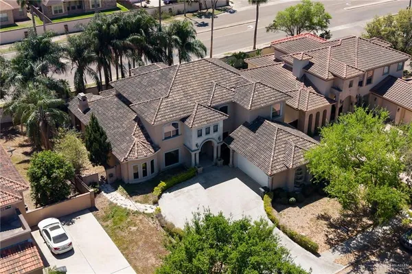 an aerial view of a house with garden space and sitting area