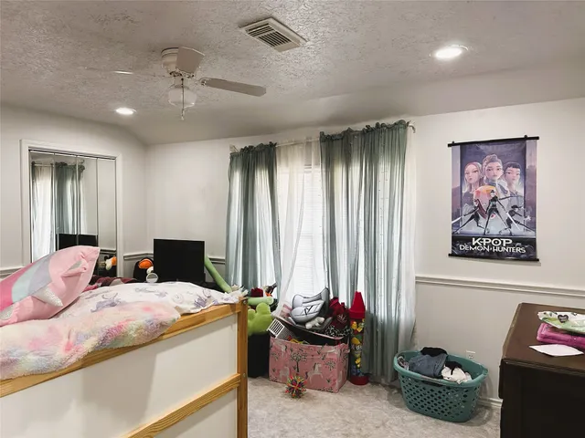 a living room with lots of furniture and clothes