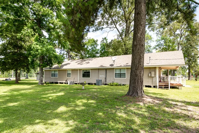 a backyard of a house with table and chairs