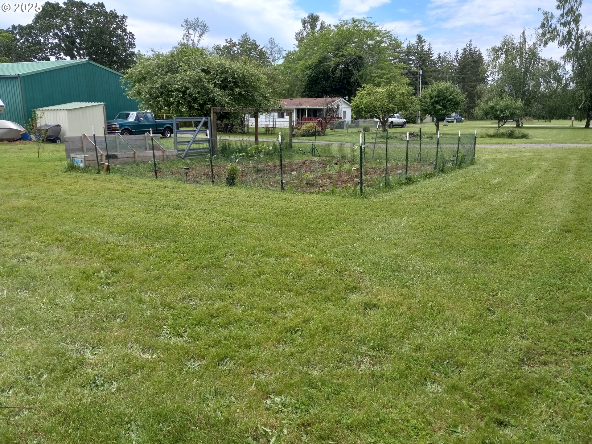 32604 South Krupicka Way Molalla, OR 97038 - Photo 12 of 18 a green field with lots of trees in the background