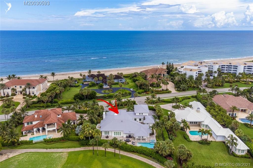 1904 Southeast Sailfish Point Boulevard Stuart, FL 34996 - Photo 1 of 72 an aerial view of a house with a garden and lake view