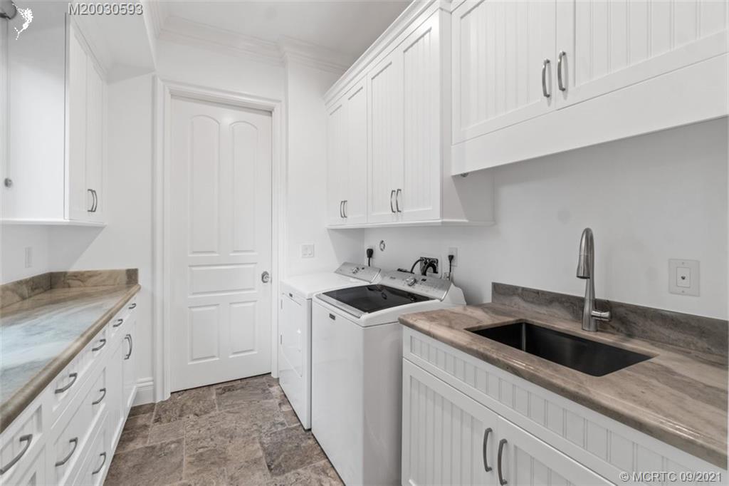 1904 Southeast Sailfish Point Boulevard Stuart, FL 34996 - Photo 17 of 72 a kitchen with granite countertop white cabinets and white appliances