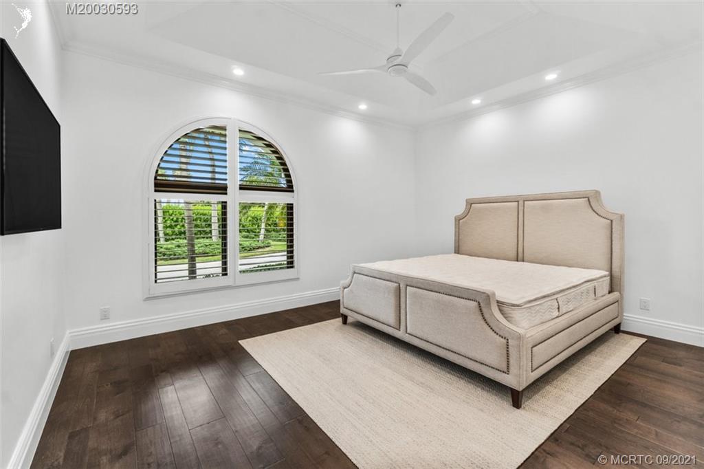 1904 Southeast Sailfish Point Boulevard Stuart, FL 34996 - Photo 18 of 72 a bed sitting in a spacious bedroom next to a window