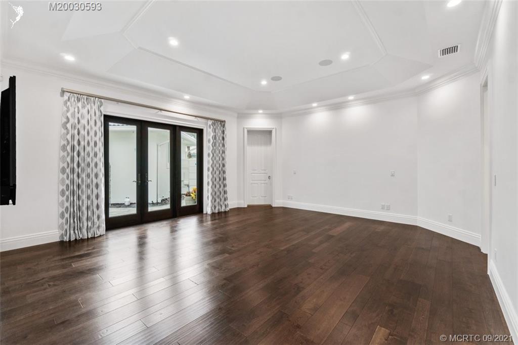 1904 Southeast Sailfish Point Boulevard Stuart, FL 34996 - Photo 28 of 72 an empty room with wooden floor and windows