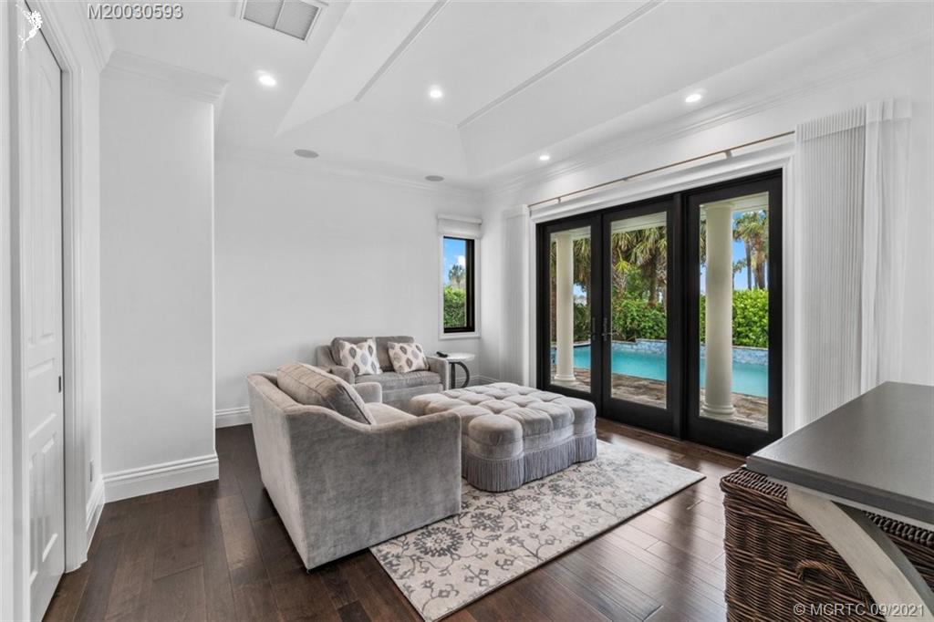 1904 Southeast Sailfish Point Boulevard Stuart, FL 34996 - Photo 30 of 72 a living room with furniture and a floor to ceiling window