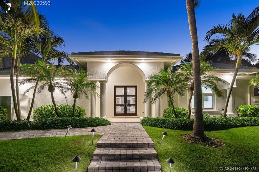 1904 Southeast Sailfish Point Boulevard Stuart, FL 34996 - Photo 36 of 72 a front view of a house with a garden