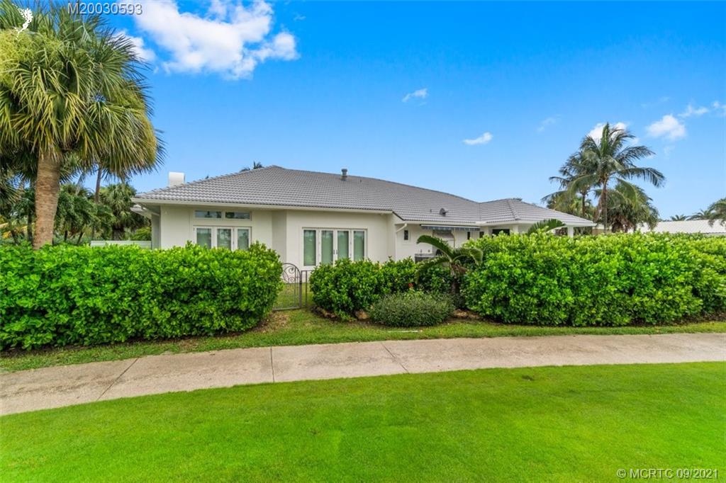 1904 Southeast Sailfish Point Boulevard Stuart, FL 34996 - Photo 52 of 72 a front view of a house with a garden