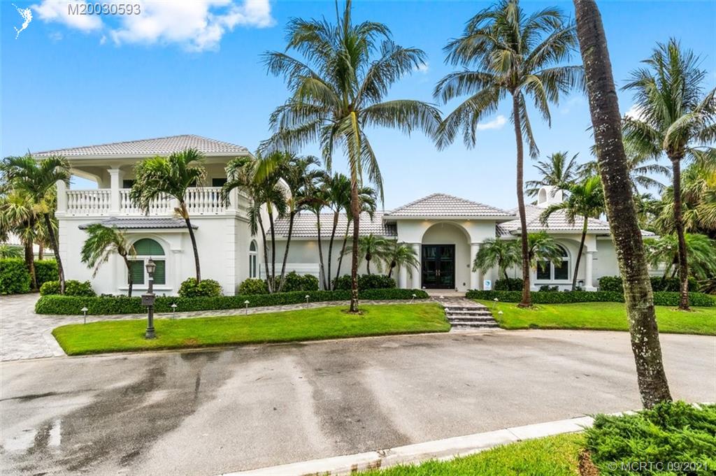 1904 Southeast Sailfish Point Boulevard Stuart, FL 34996 - Photo 54 of 72 a front view of a house with a garden and trees