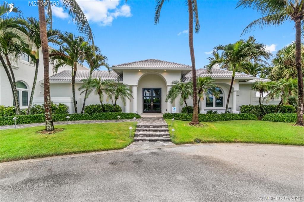 1904 Southeast Sailfish Point Boulevard Stuart, FL 34996 - Photo 57 of 72 a front view of a house with garden and porch