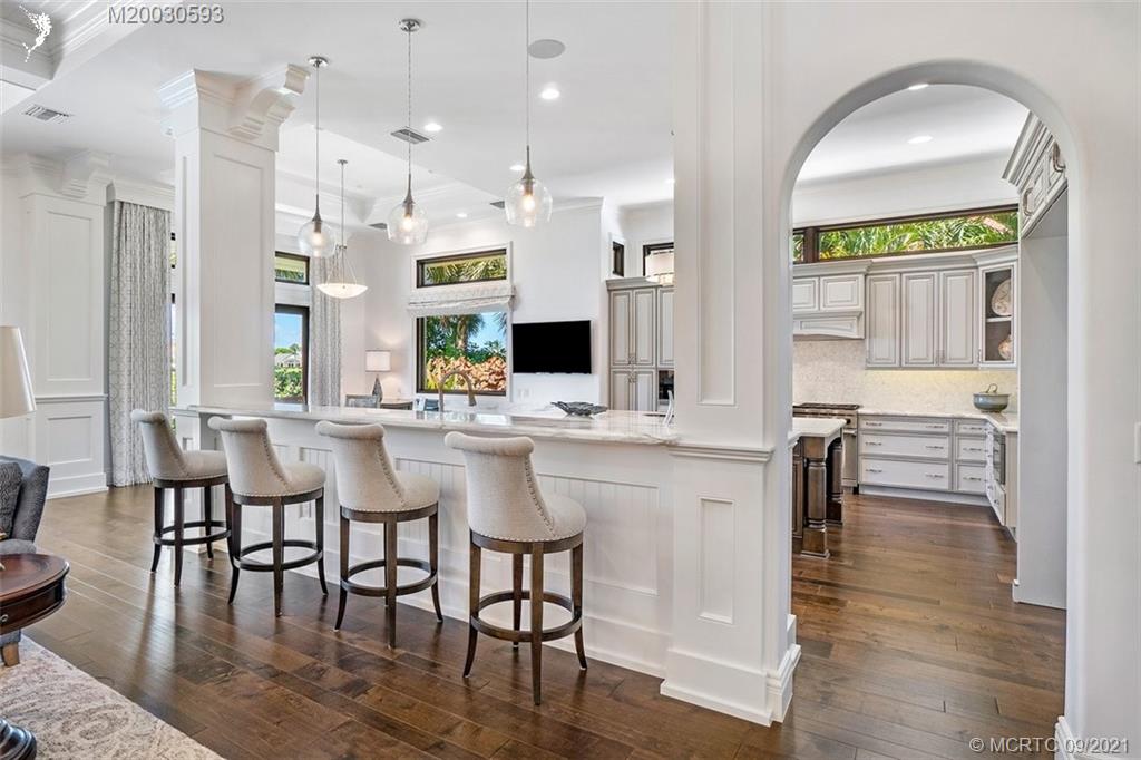 1904 Southeast Sailfish Point Boulevard Stuart, FL 34996 - Photo 6 of 72 a view of dining room kitchen with stainless steel appliances kitchen island granite countertop a table chairs and a refrigerator