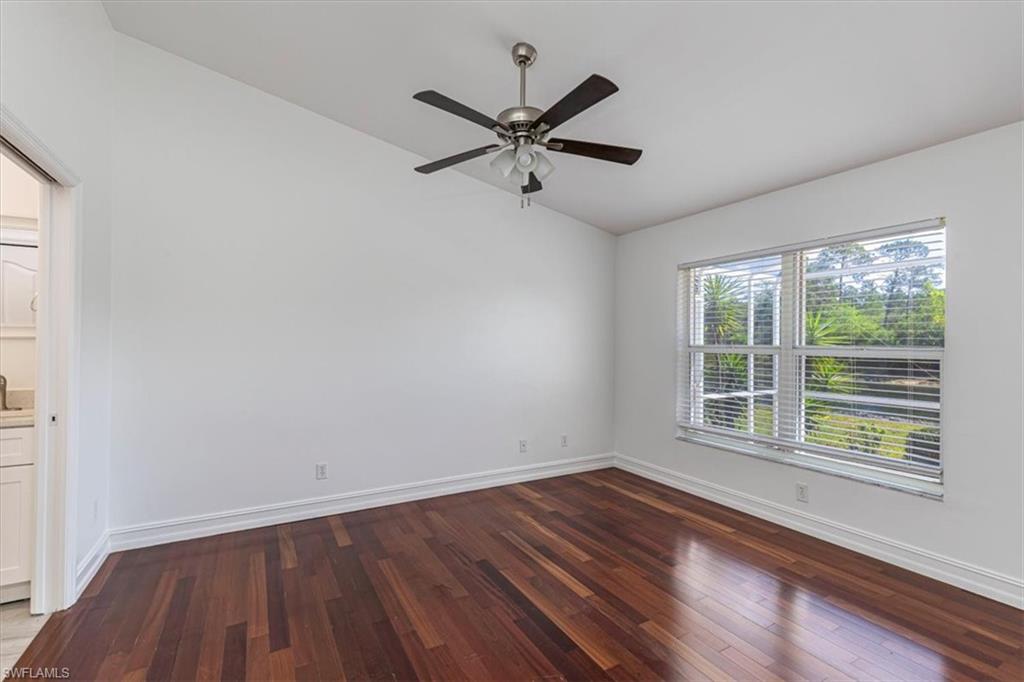 5446 Whitten Drive, Unit 19 Naples, FL 34104 - Photo 11 of 24 a view of a room with wooden floor and windows