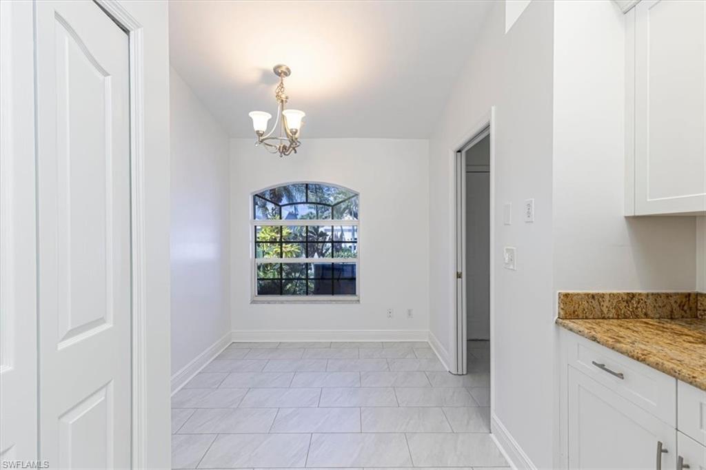5446 Whitten Drive, Unit 19 Naples, FL 34104 - Photo 12 of 24 a view of an empty room with a window
