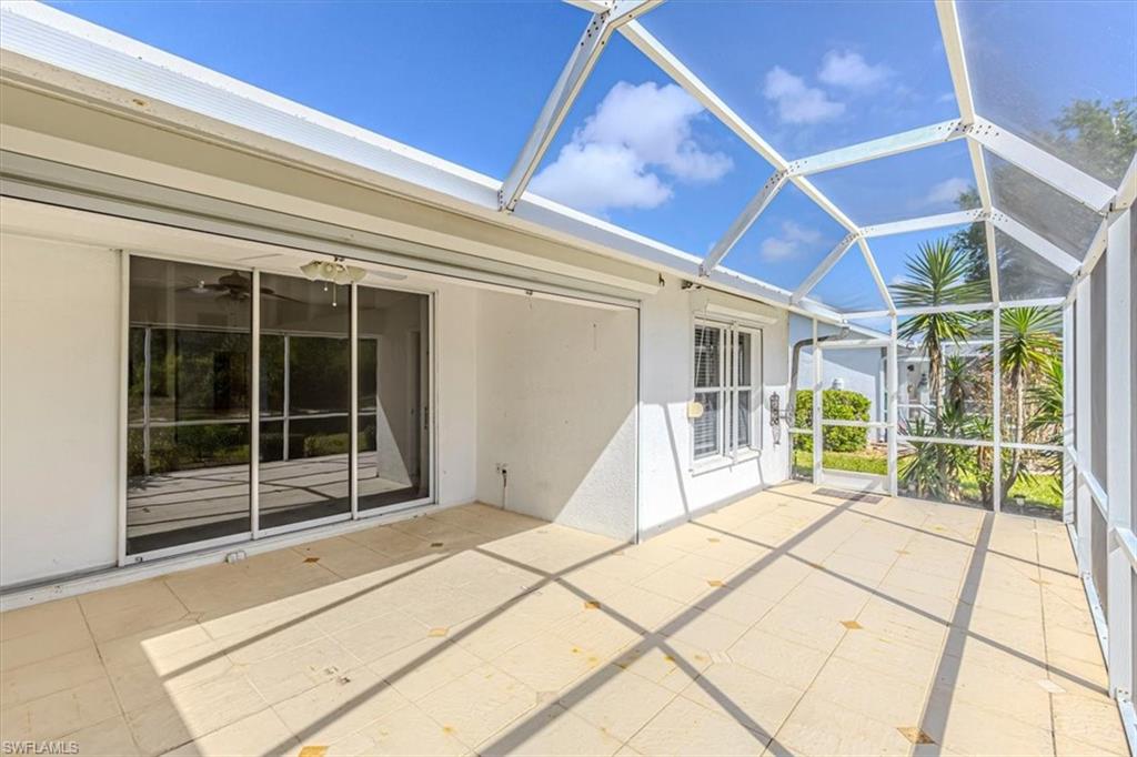 5446 Whitten Drive, Unit 19 Naples, FL 34104 - Photo 20 of 24 a view of a porch with wooden floor and iron stairs