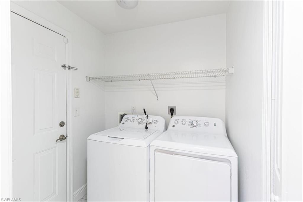5446 Whitten Drive, Unit 19 Naples, FL 34104 - Photo 21 of 24 a utility room with dryer and washer