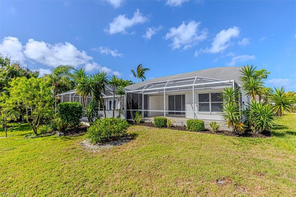 5446 Whitten Drive, Unit 19 Naples, FL 34104 - Photo 23 of 24 a front view of a house with a yard