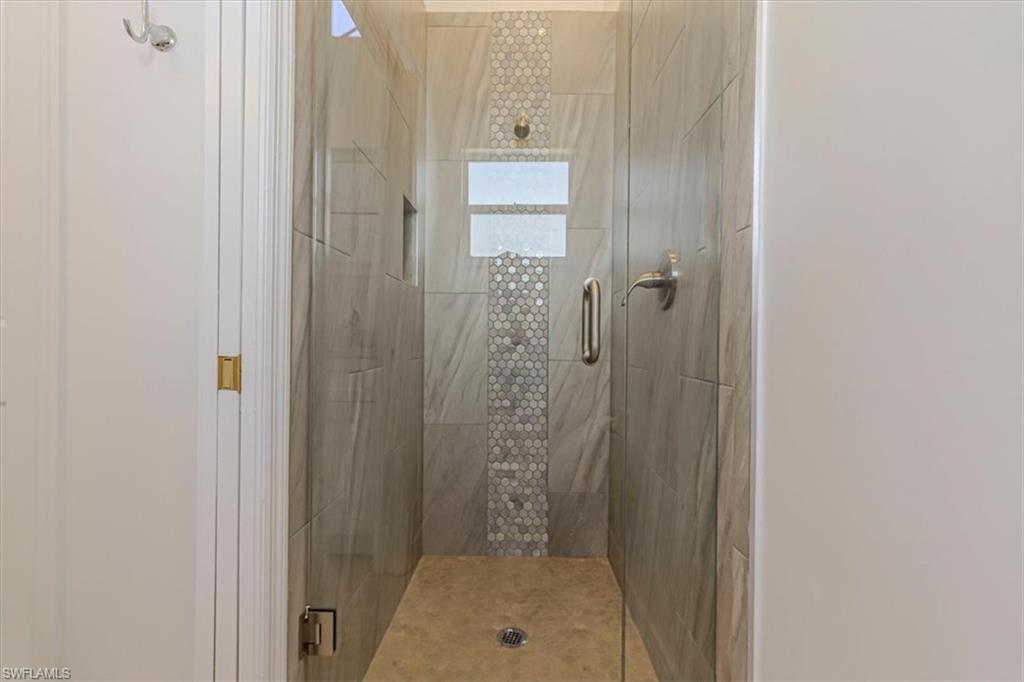 5446 Whitten Drive, Unit 19 Naples, FL 34104 - Photo 8 of 24 a bathroom with a shower and a toilet