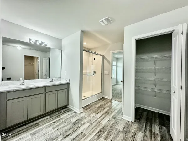 a bathroom with a double vanity sink and a mirror
