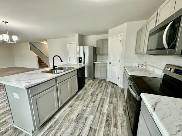 a kitchen with a sink stove and refrigerator