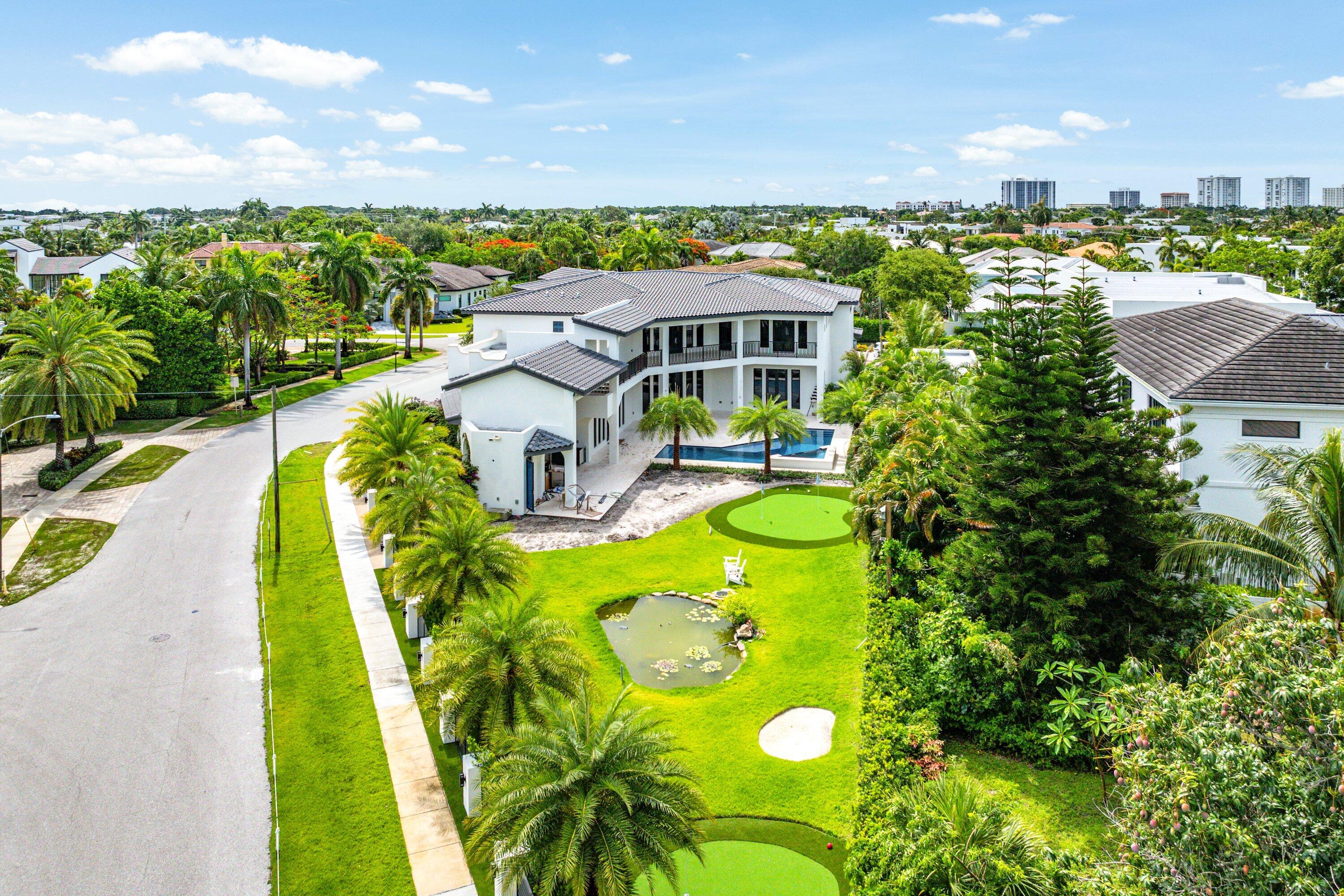 298 Northeast 8th Street Boca Raton, FL 33432 - Photo 84 of 86 a view of a swimming pool with a patio
