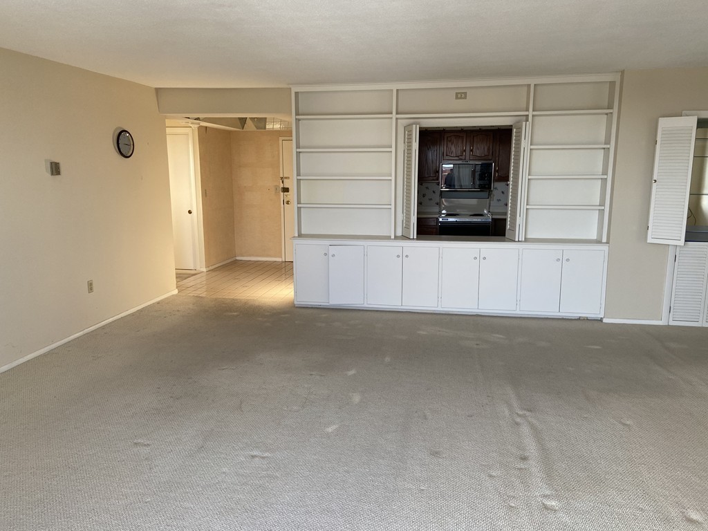 80 Salisbury Street, Unit 603 Worcester, MA 01609 - Photo 8 of 18 a view of empty room with a fireplace and cabinet