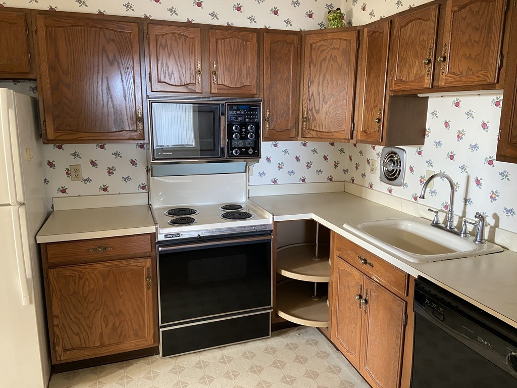 80 Salisbury Street, Unit 603 Worcester, MA 01609 - Photo 9 of 18 a kitchen with granite countertop a stove sink and cabinets