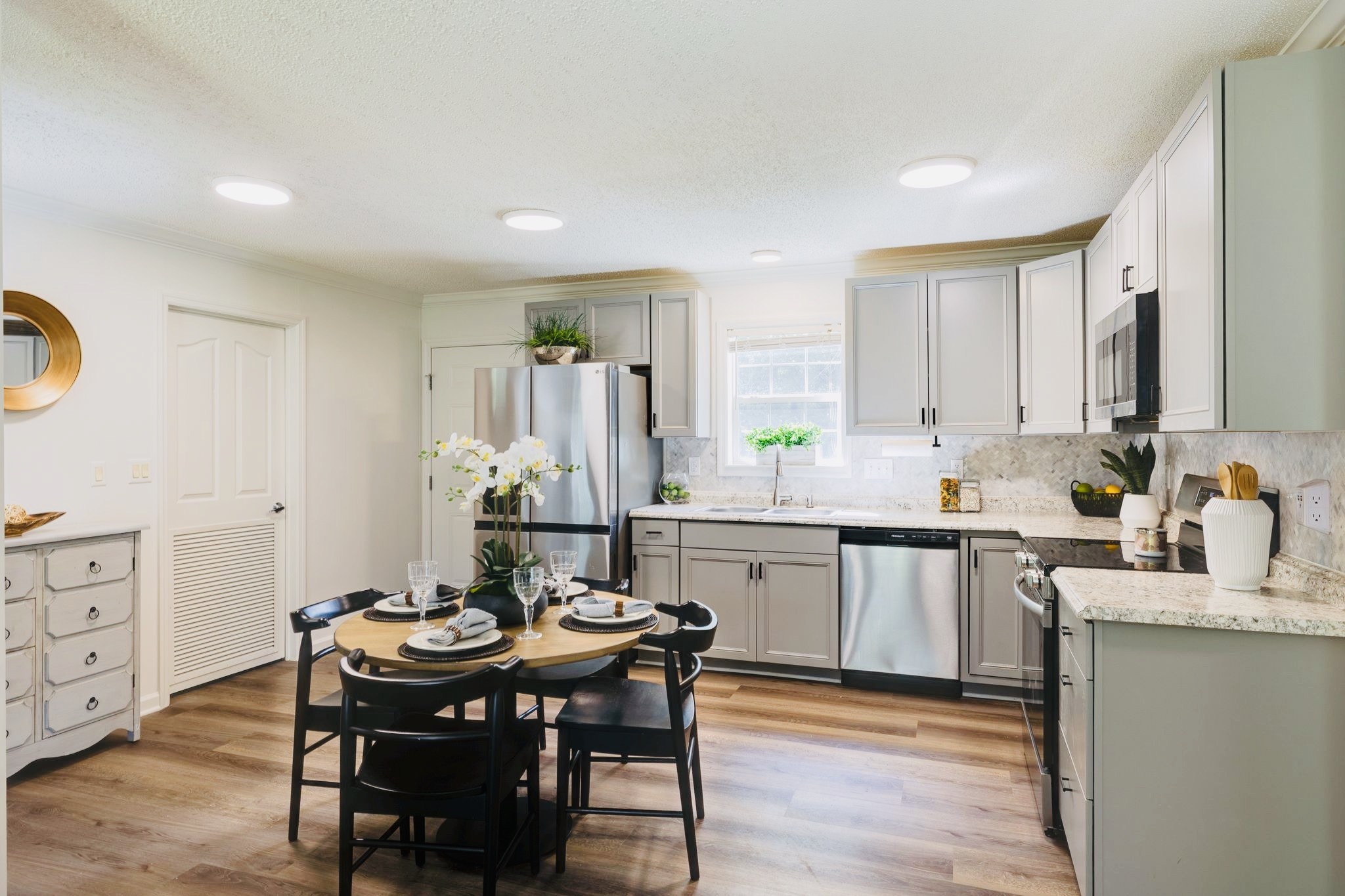 a kitchen with granite countertop a sink and white appliances