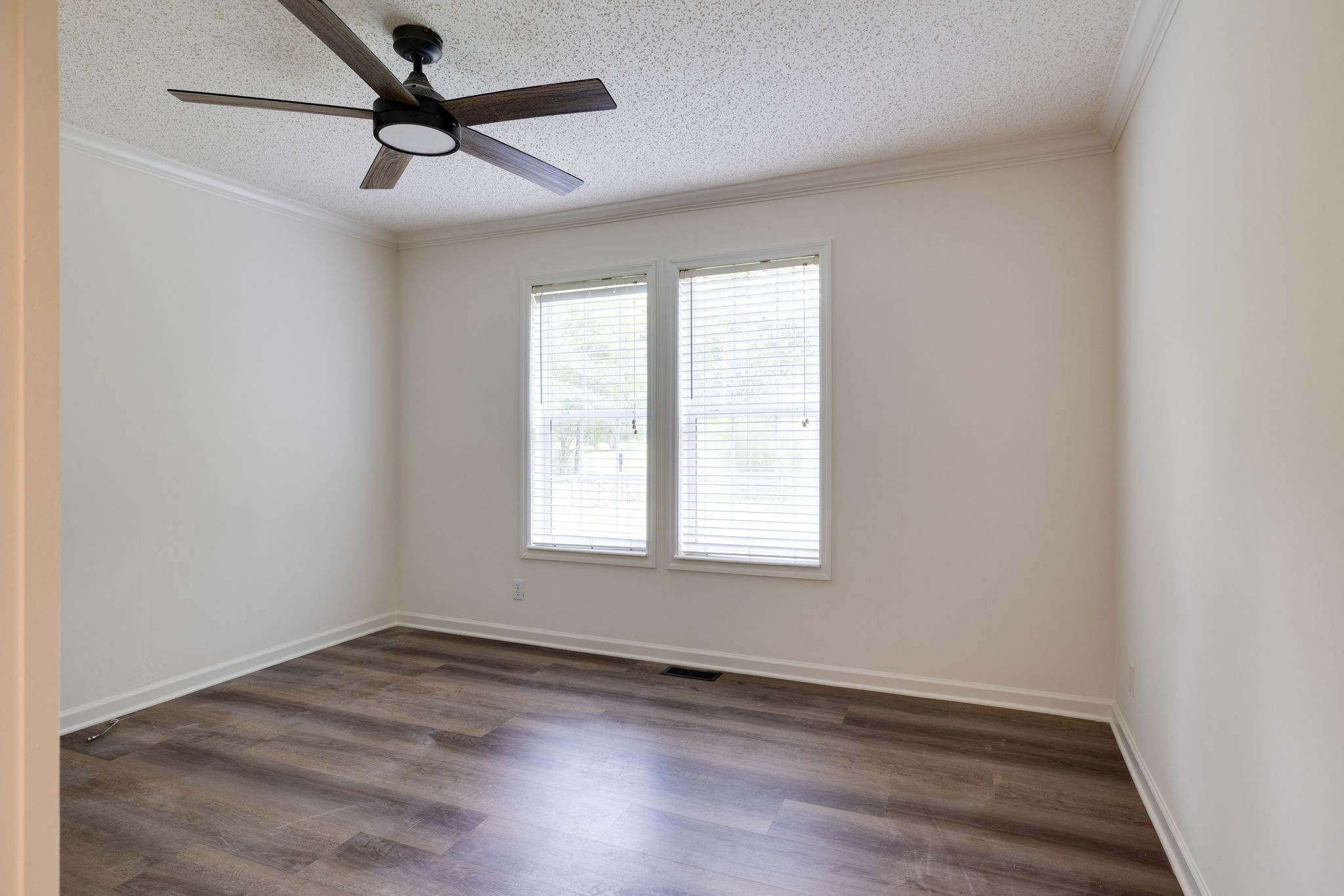 3921 Johnson Hollow Road Thompson's Station, TN 37179 - Photo 11 of 38 an empty room with wooden floor ceiling fan and windows