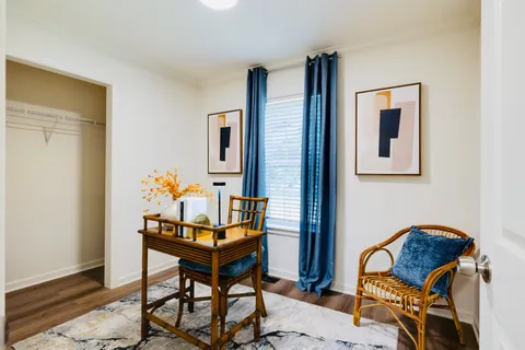 a dining room with furniture and wooden floor