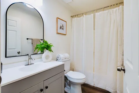 a bathroom with a sink toilet and shower