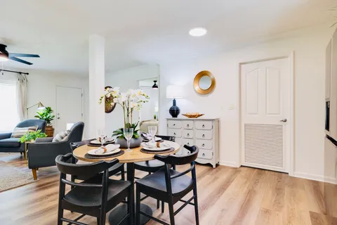 a dining room with furniture and window