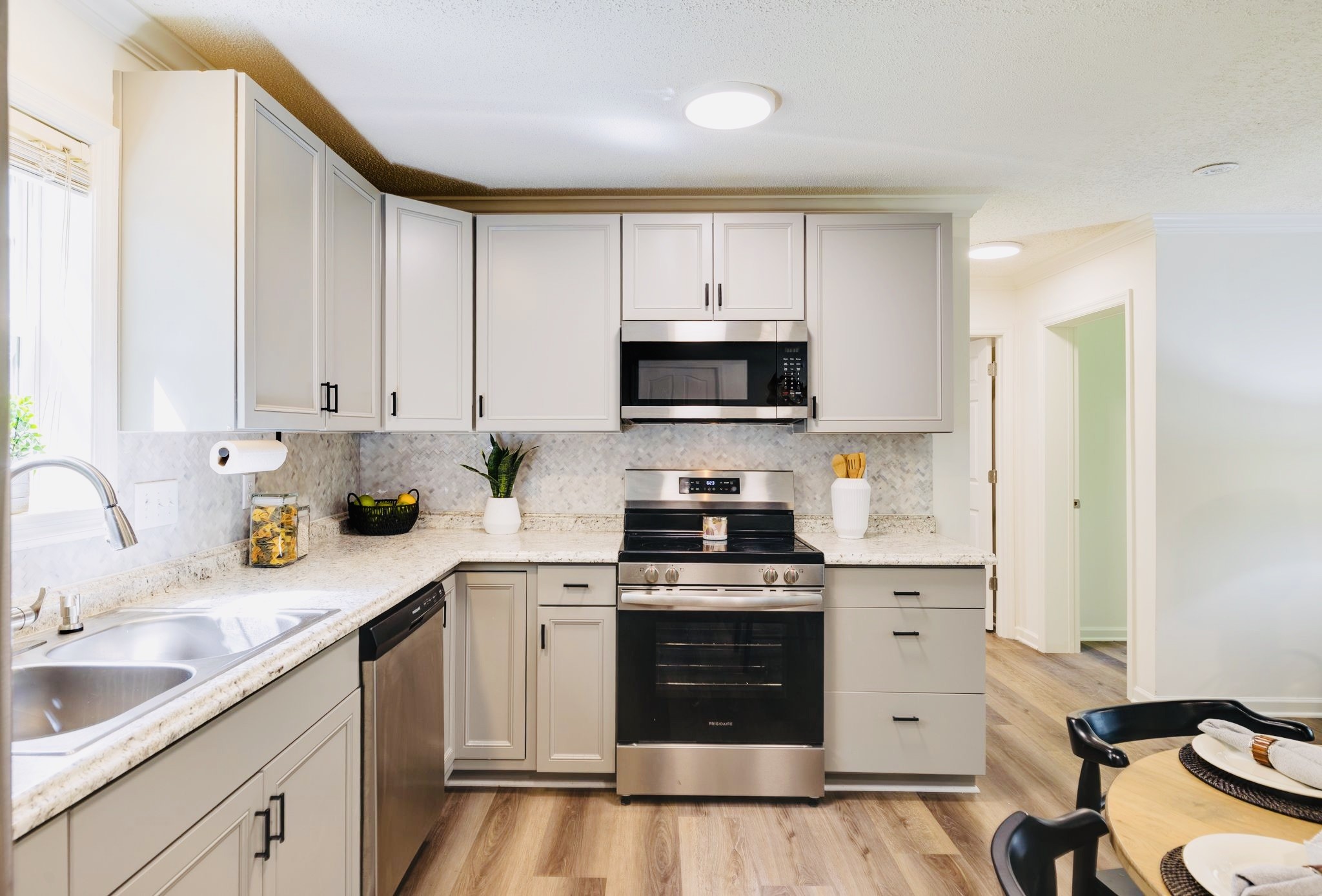 3921 Johnson Hollow Road Thompson's Station, TN 37179 - Photo 5 of 38 a kitchen with stainless steel appliances granite countertop a stove a sink dishwasher and a refrigerator with wooden cabinets