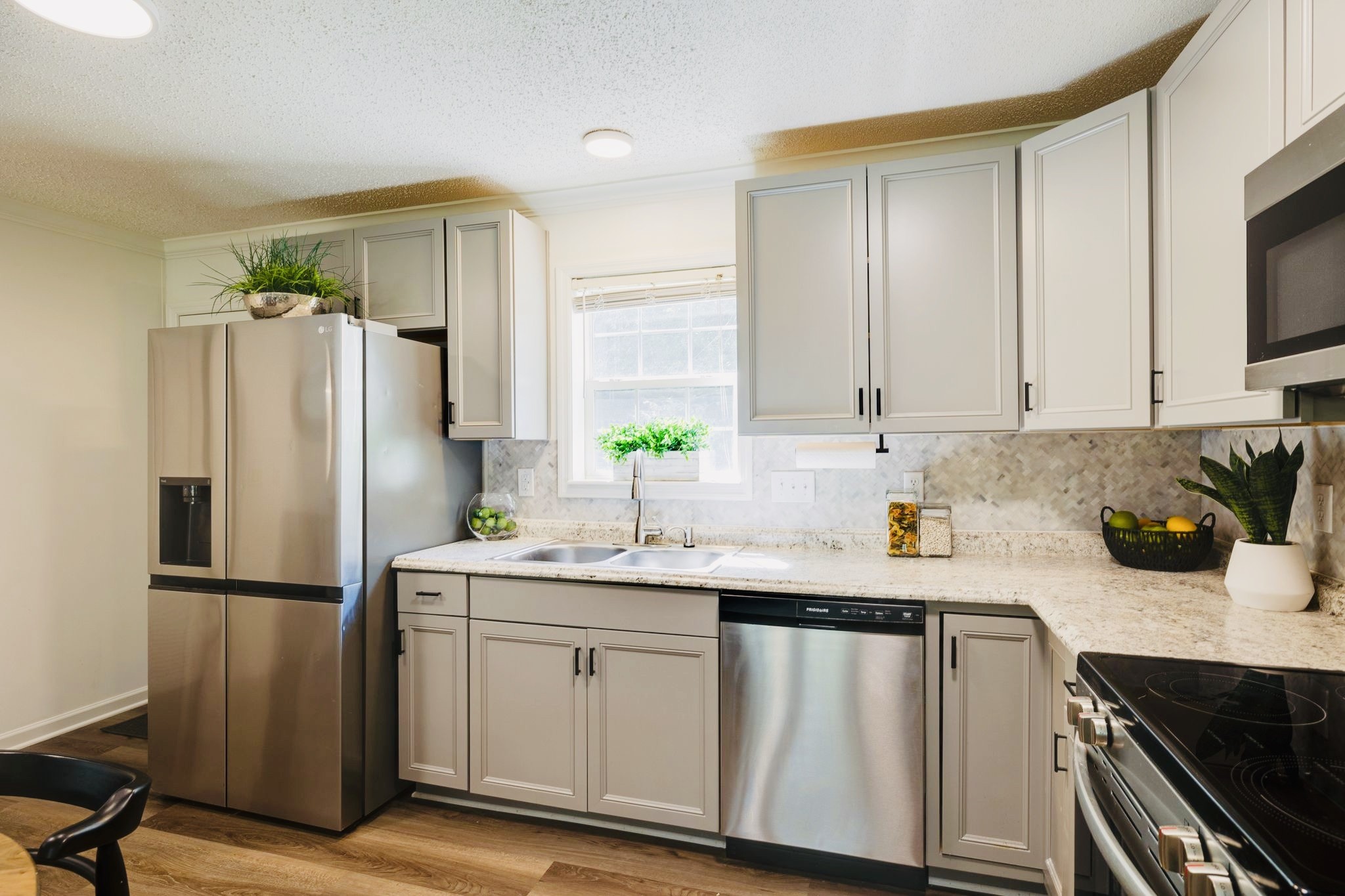 3921 Johnson Hollow Road Thompson's Station, TN 37179 - Photo 6 of 38 a kitchen with stainless steel appliances a sink cabinets and a refrigerator