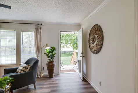 a view of a livingroom with furniture window and wooden floor