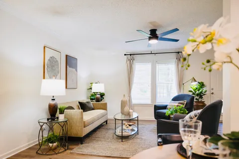 a living room with furniture and flowers