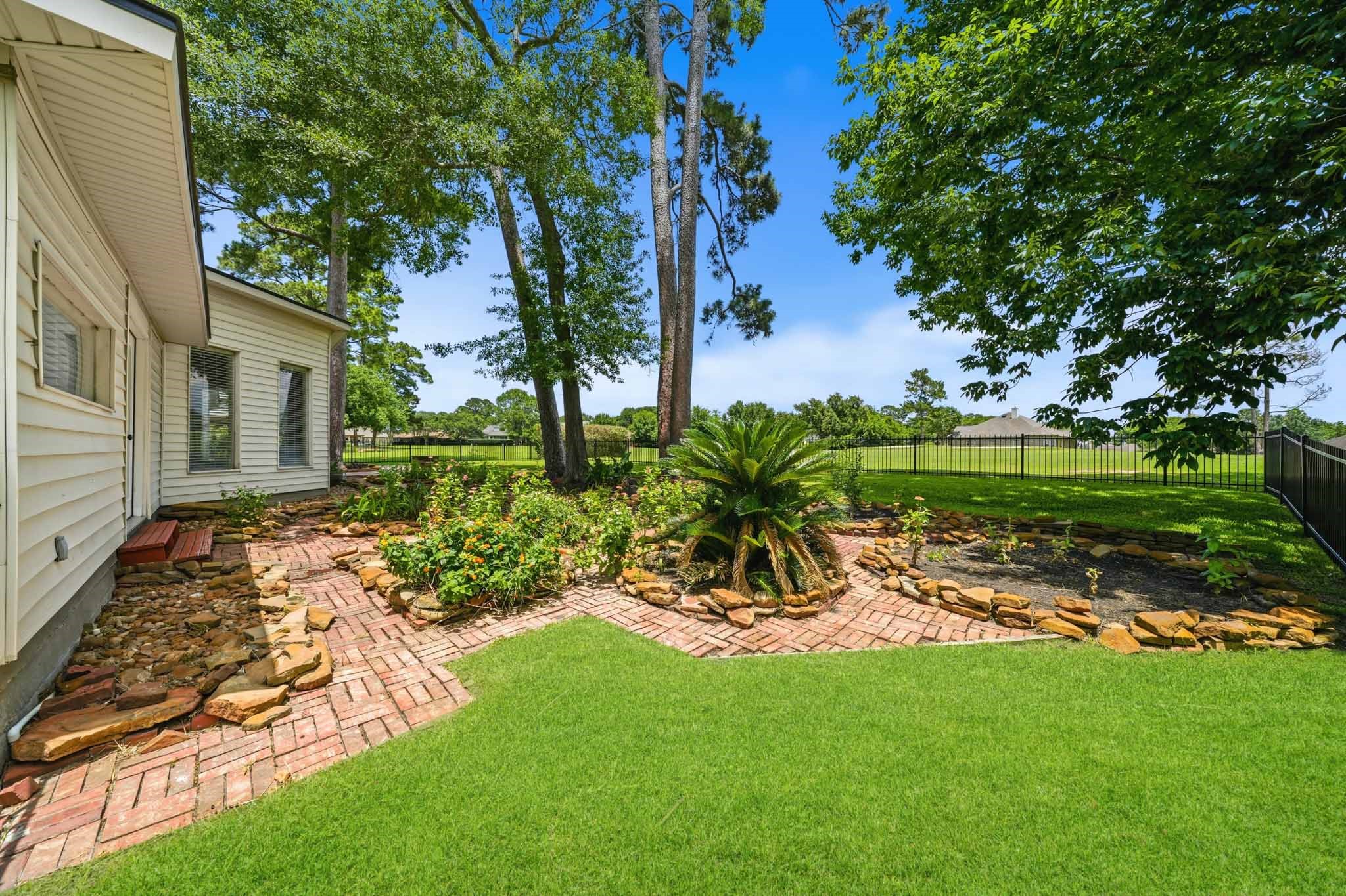 79 Summers Wind Street Conroe, TX 77356 - Photo 33 of 45 a view of a backyard with a garden and plants