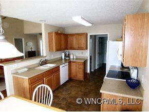 93 Morning Mist Road Fletcher, NC 28732 - Photo 3 of 12 a kitchen with granite countertop a stove a sink and a refrigerator
