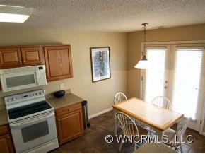 93 Morning Mist Road Fletcher, NC 28732 - Photo 4 of 12 a kitchen that has a stove and a microwave