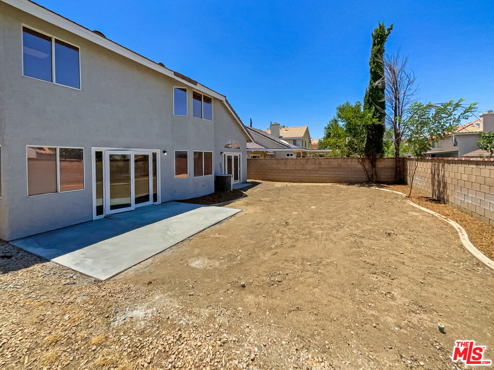 1615 East Kettering Street Lancaster, CA 93535 - Photo 5 of 15 a house with trees in front of it
