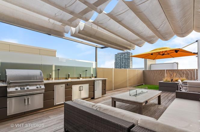 1132 West Adams Street, Unit PHE Chicago, IL 60607 - Photo 19 of 23 a living room with stainless steel appliances kitchen island granite countertop a stove and a sink